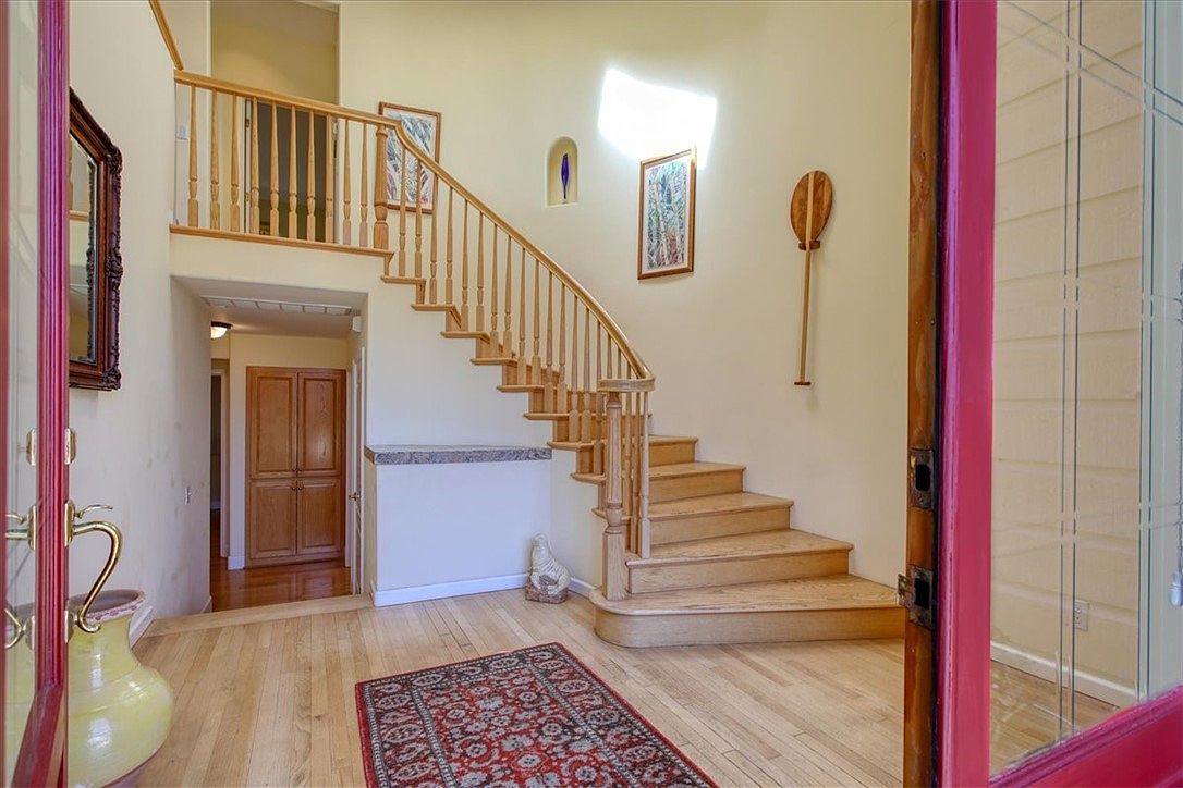 Open-plan upstairs living and dining with high ceilings.