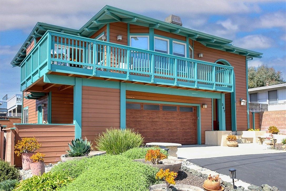 The teal-trimmed Cambria Craftsman at 347 Ivar Street, framed by drought-tolerant landscaping and a clear coastal sky.
